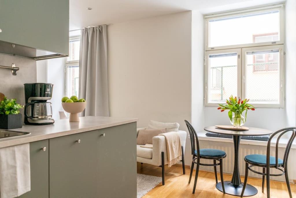 a kitchen and dining room with a table and chairs at Cozy Studio with private Sauna in Helsinki