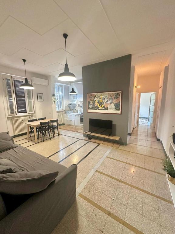 a living room with a fireplace and a dining room at Maison San Lorenzo Roma in Rome