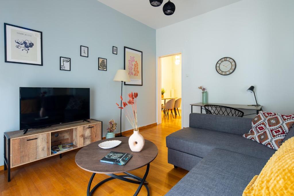 a living room with a couch and a tv at Feels like home apartment next to Acropolis in Athens