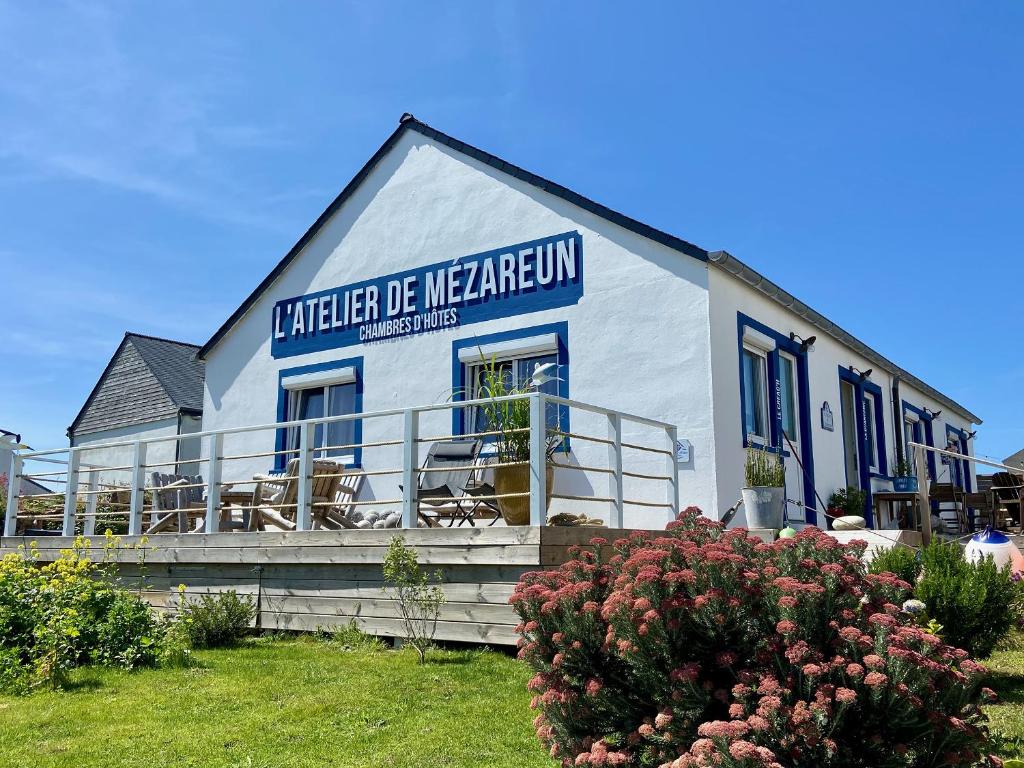 a white building with a sign on the side of it at L'Atelier de Mézareun in Ouessant