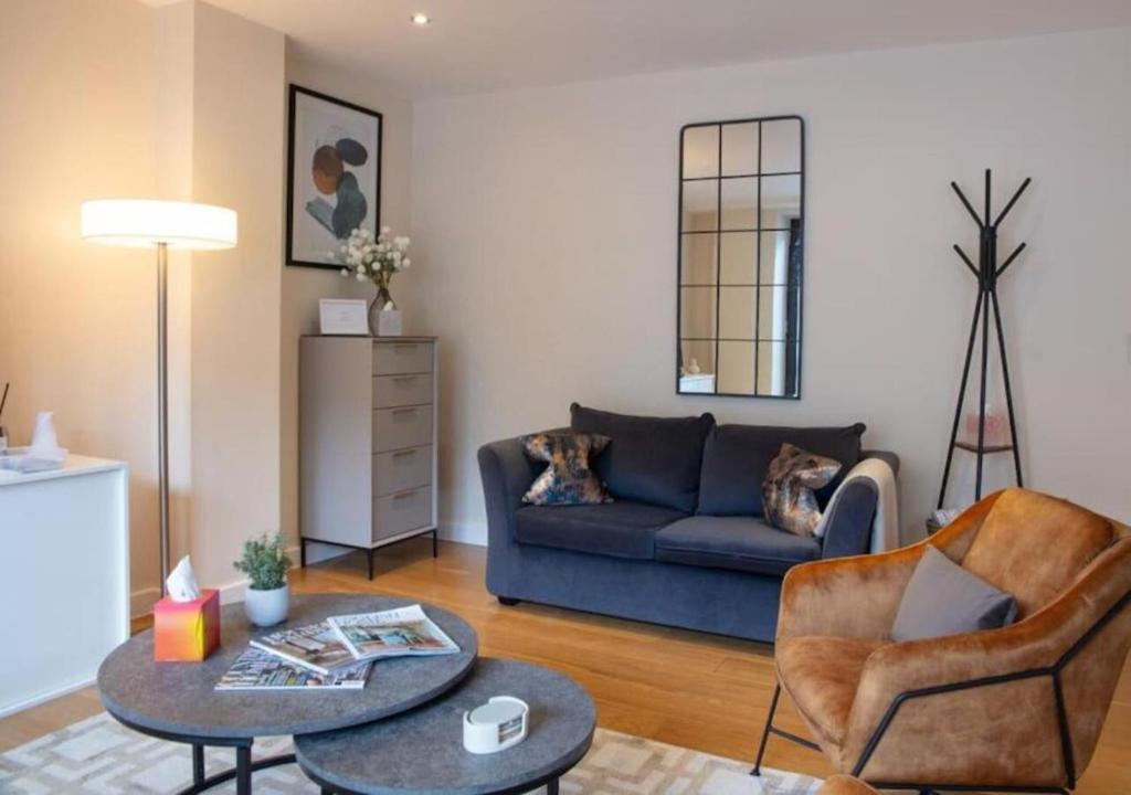 a living room with a blue couch and a table at Westminster 1 bed apt with terrace in London