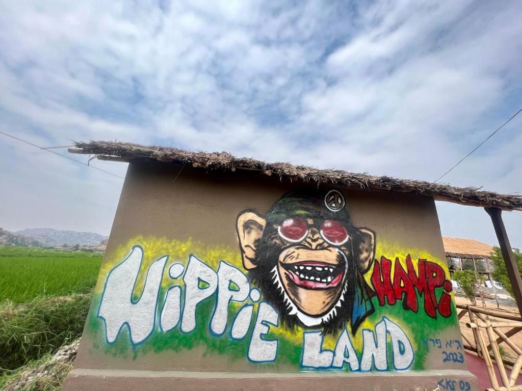 a painting of a monkey on the side of a building at Hippie Land Nature Stay in Hampi
