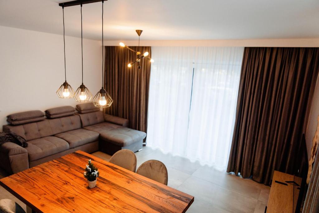 a living room with a table and a couch at Park View Apartment 1 in Sighetu Marmaţiei