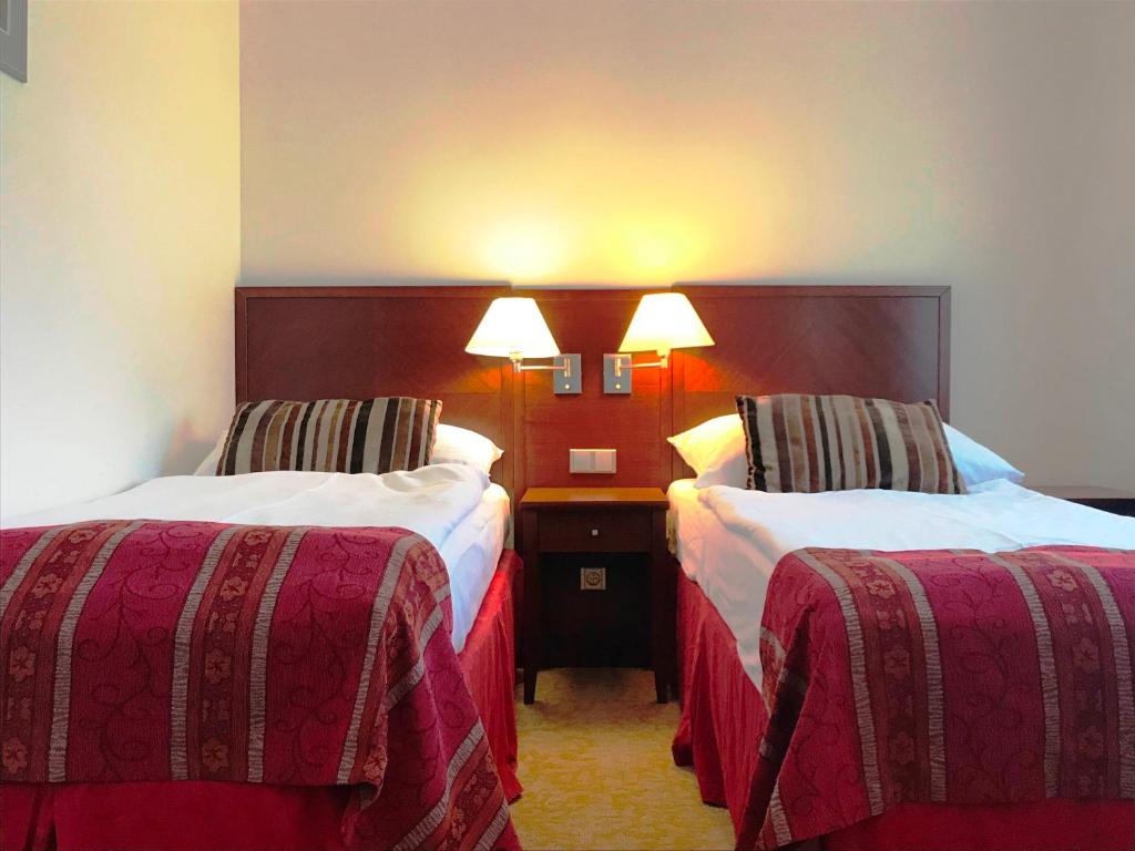 Postel nebo postele na pokoji v ubytování Hotel Atrium
