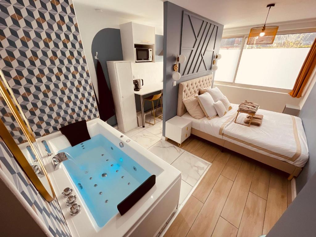 a living room with a tub in the middle of a room at La balnéo de l'impératrice Anastasia - 306 in Rouen