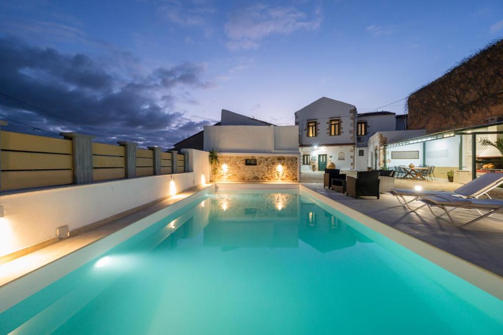 a swimming pool in the middle of a house at night at Mar Traditional Mansion in Arónion