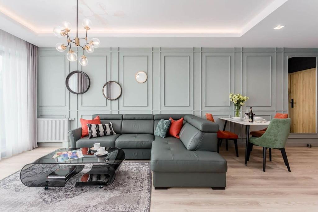 a living room with a couch and a table at Rent like home - Apartamenty DEO PLAZA in Gdańsk