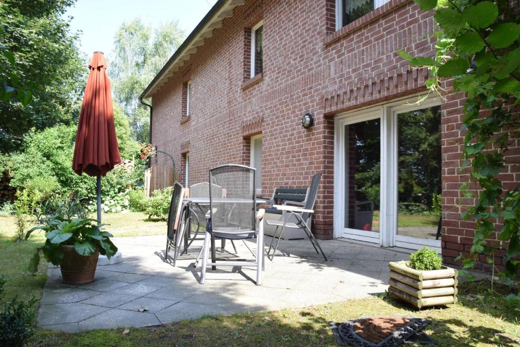 a patio with a table and an umbrella at Ferienwohnung Eulenhof in Templin