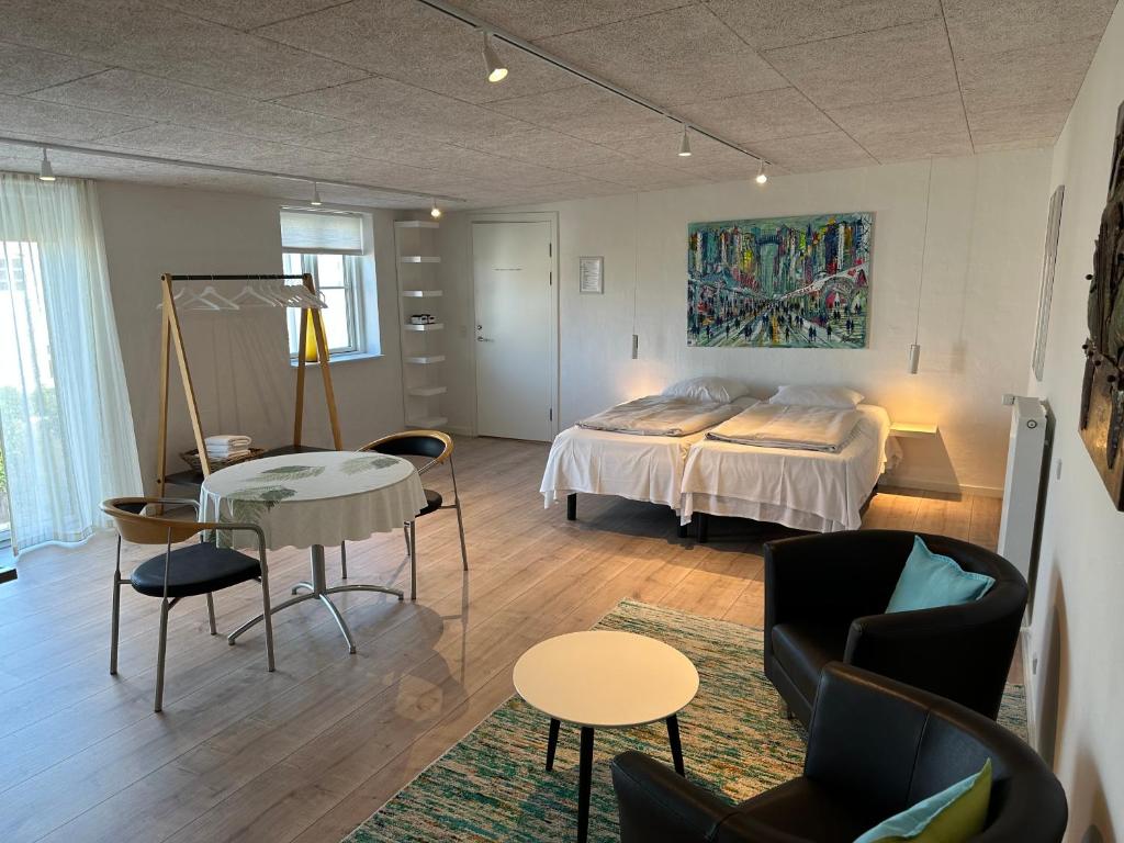 Lucky 3 Apartments في لوكين: غرفة نوم بسرير وطاولة وكراسي