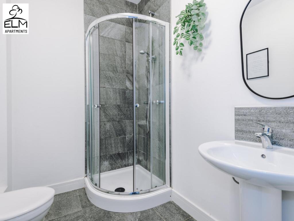 a shower in a bathroom with a toilet and a sink at Elm Aparthotel , Collection of apartments Available Near Media City , Free Parking in Manchester
