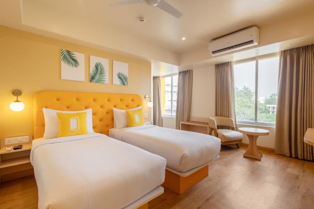 Postel nebo postele na pokoji v ubytování Bloom Hotel - Ranchi