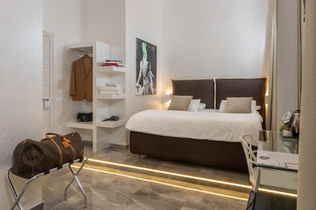 a bedroom with a large bed and a glass table at DolceVitaSuite in Rome