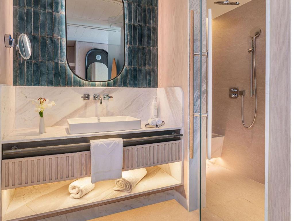a bathroom with a sink and a shower at Swissotel Resort And Spa Cesme in Çeşme
