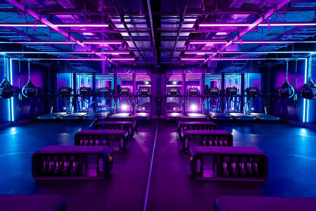 a room with purple lights and rows of chairs at Hilton Bournemouth in Bournemouth