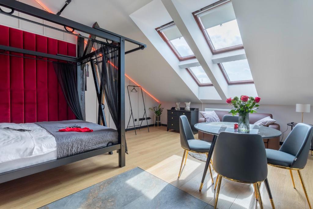 a bedroom with a bed and a table and chairs at Exclusive BDSM Apartment Kraków - ADULTS ONLY in Krakow