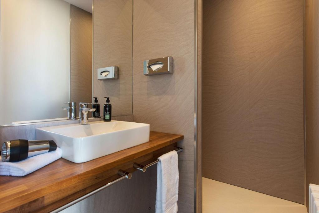 a bathroom with a sink and a mirror at Best Western Hotel De La Plage Saint Marc sur Mer in Saint-Nazaire