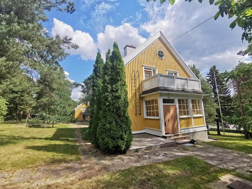 a yellow house with a porch at Rauma Room's House 9 200m2 in Rauma