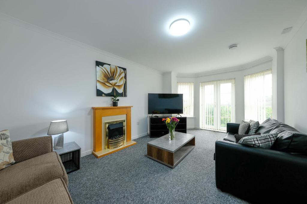 a living room with a couch and a fireplace at Pure Apartments 2 Bed Duloch - Dunfermline in Fife