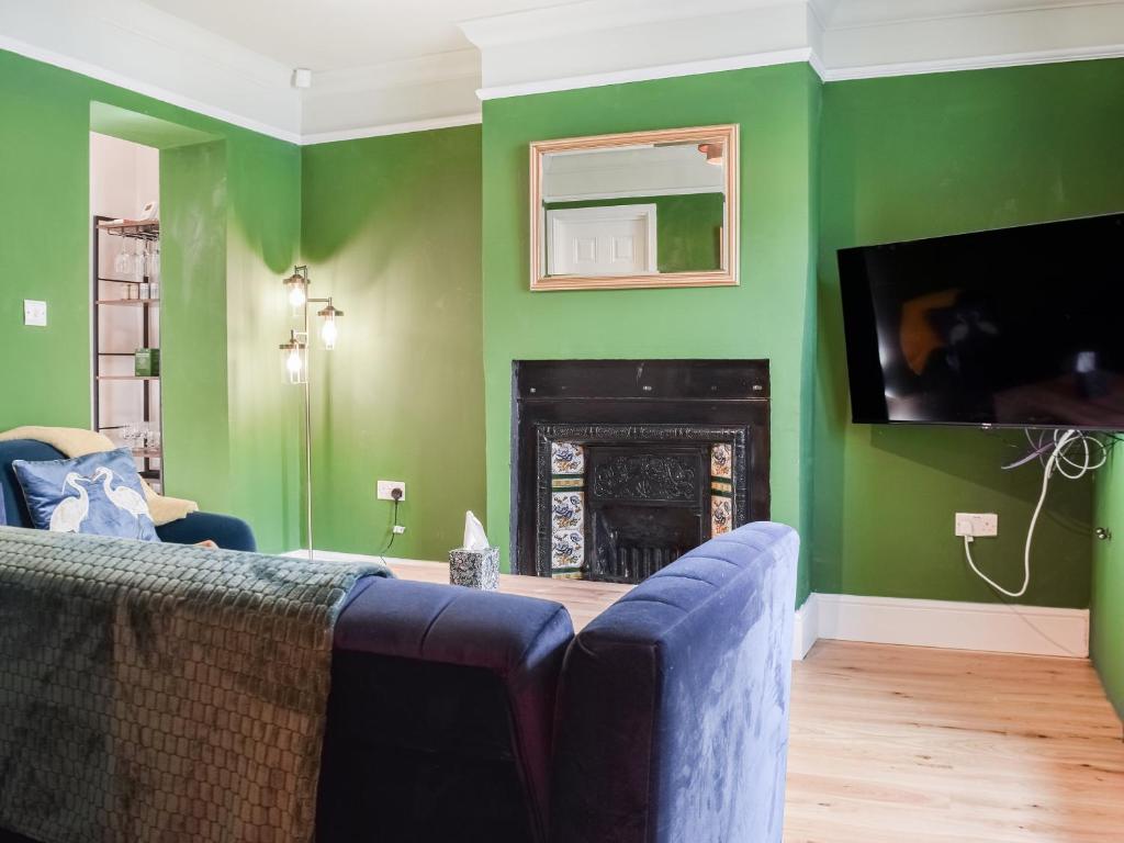 a living room with a couch and a fireplace at The Bolthole in Bolton