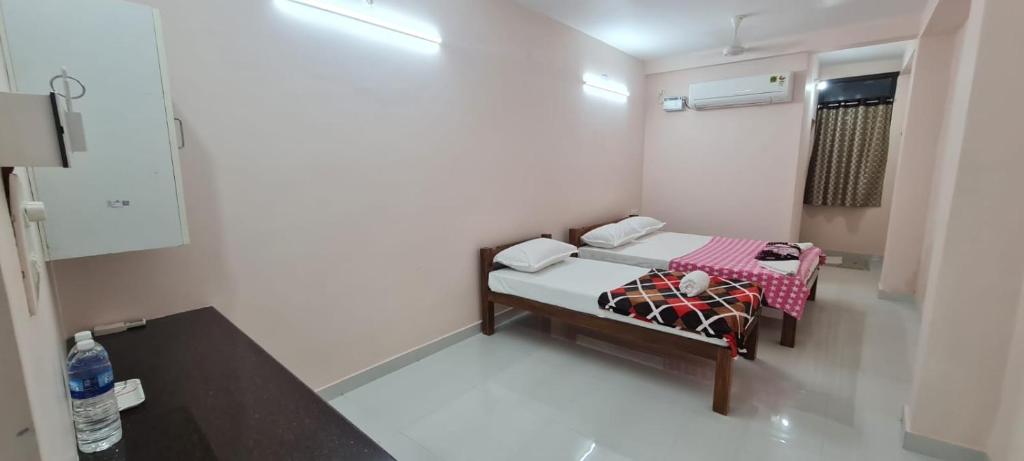 Ένα ή περισσότερα κρεβάτια σε δωμάτιο στο Rithu Homestay, Pondicherry