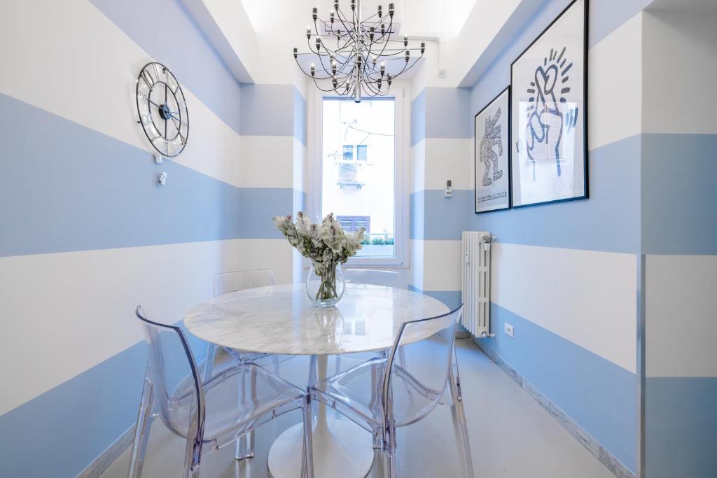 a dining room with a white table and chairs at Vatican Apartment near Metro Ottaviano in Rome