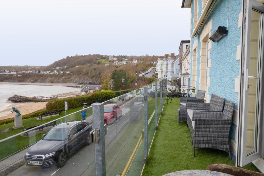 a balcony with a car parked on a street at No. 1 Cliffside New Quay in New Quay