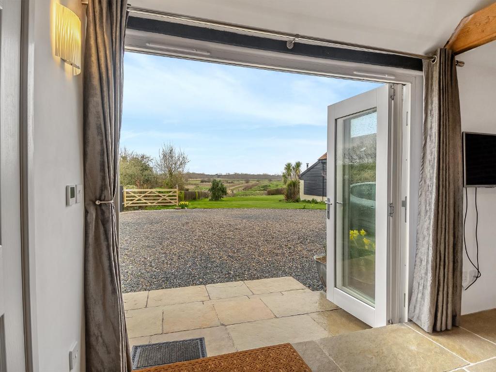 an open door with a view of a driveway at Waveney Valley View in Burgh Saint Peter