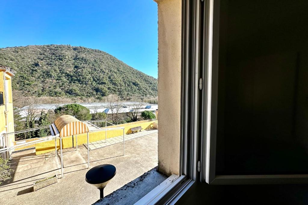 a window with a view of a mountain at E20 Les Naïades- 2 bedrooms for 5 people ! in Avène