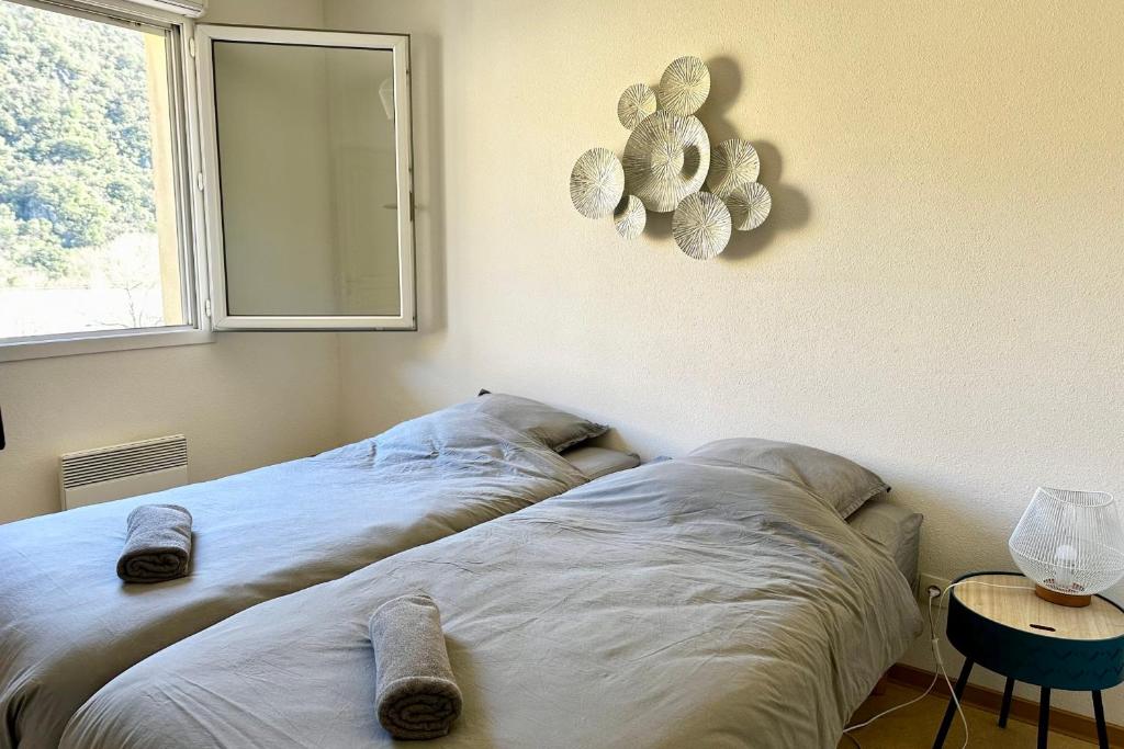 a bedroom with two beds and a window at Les Naïades E20 - 2 bedrooms for 5 people ! in Avène
