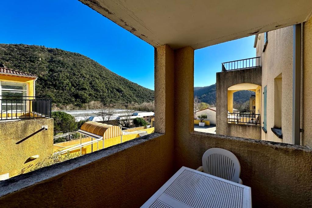 a balcony with a view of a mountain at E20 Les Naïades- 2 bedrooms for 5 people ! in Avène