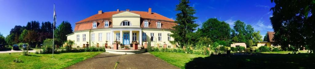 una grande casa con tetto rosso su un prato di 5 Sternberg a Borkow