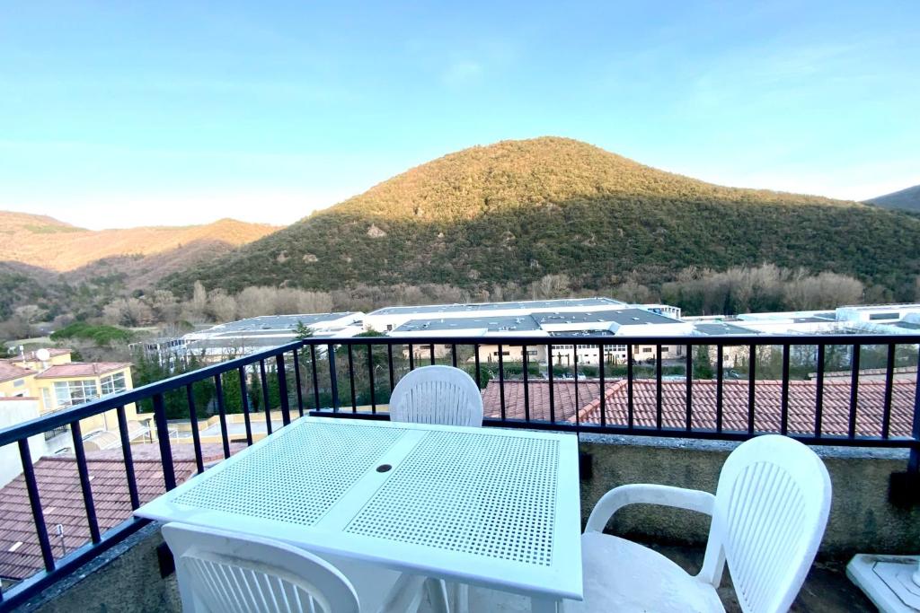 a white table and chairs on a balcony with mountains at Les Naïades G37- 2 bedrooms for 5 people ! in Avène
