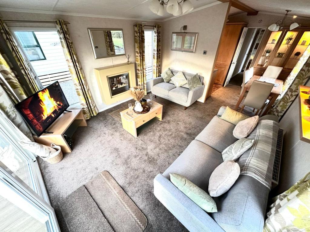 an overhead view of a living room with a couch and a tv at Impeccable 2-Bed Lodge in Preston hot hub in Preston