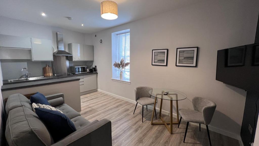 a living room with a couch and a table at St John's Apartments in Perth