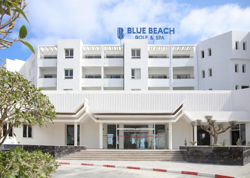 a white building with a blue beach cafe and spa at Blue Beach Golf and Spa in Monastir