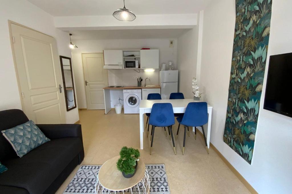 a living room with a couch and a table and chairs at Les Naïades I47 - 2 bedrooms for 5 people ! in Avène
