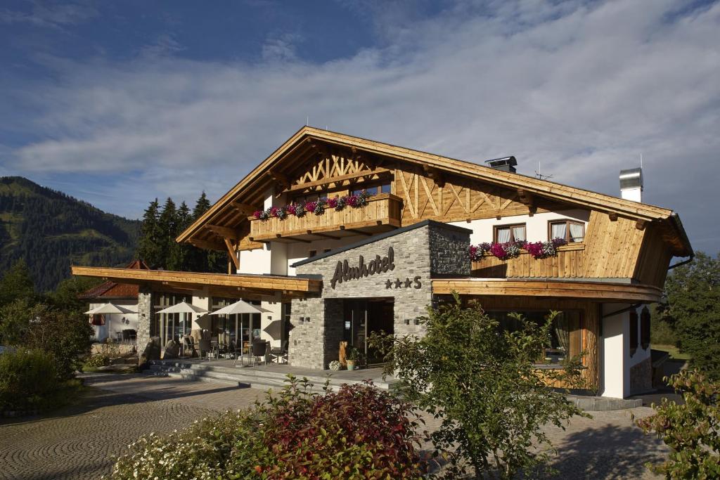 a building with a balcony on top of it at Almhotel Told in Grän