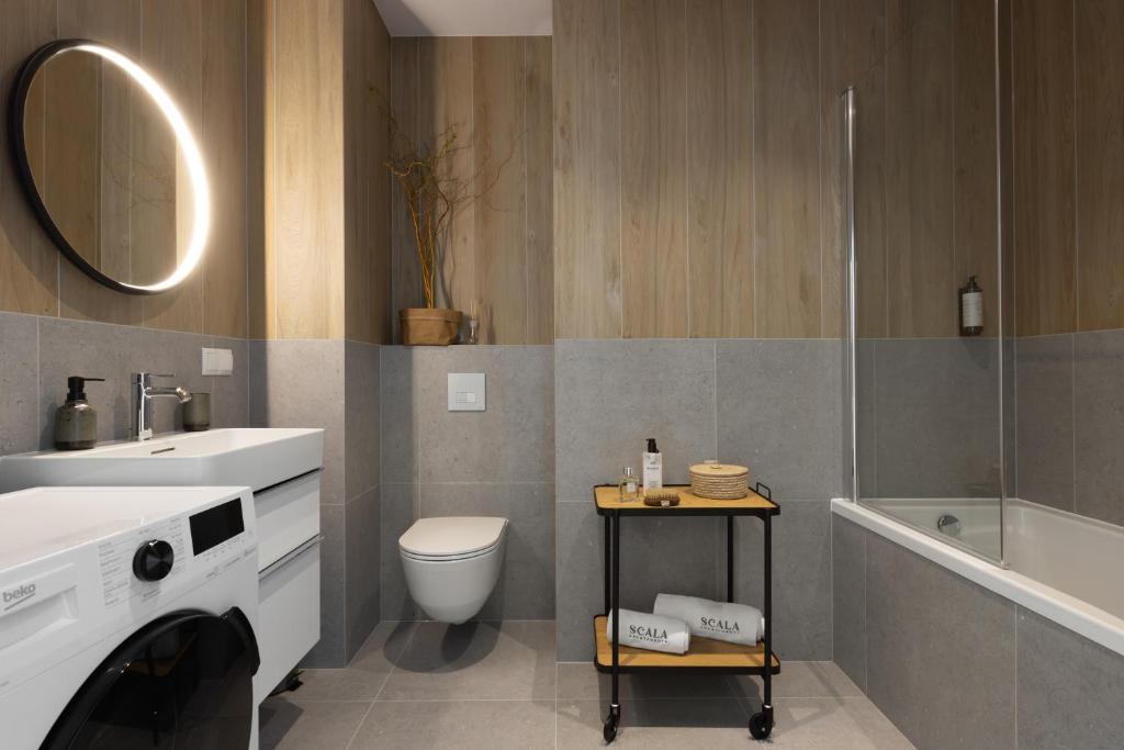 a bathroom with a sink and a toilet and a shower at Scala Apartamenty by Moderna Profit- Łąkowa 60E z parkingiem in Gdańsk
