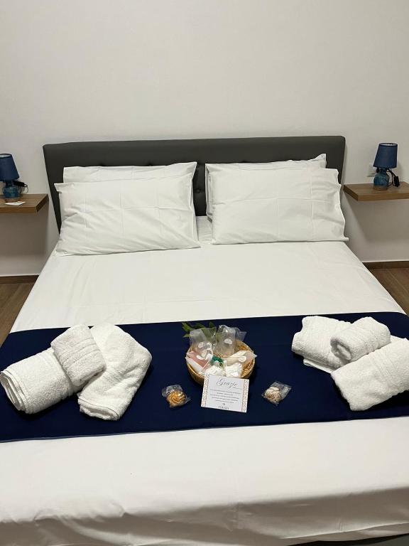 a bed with towels and other items on it at Baglio Eldama in Castelvetrano Selinunte