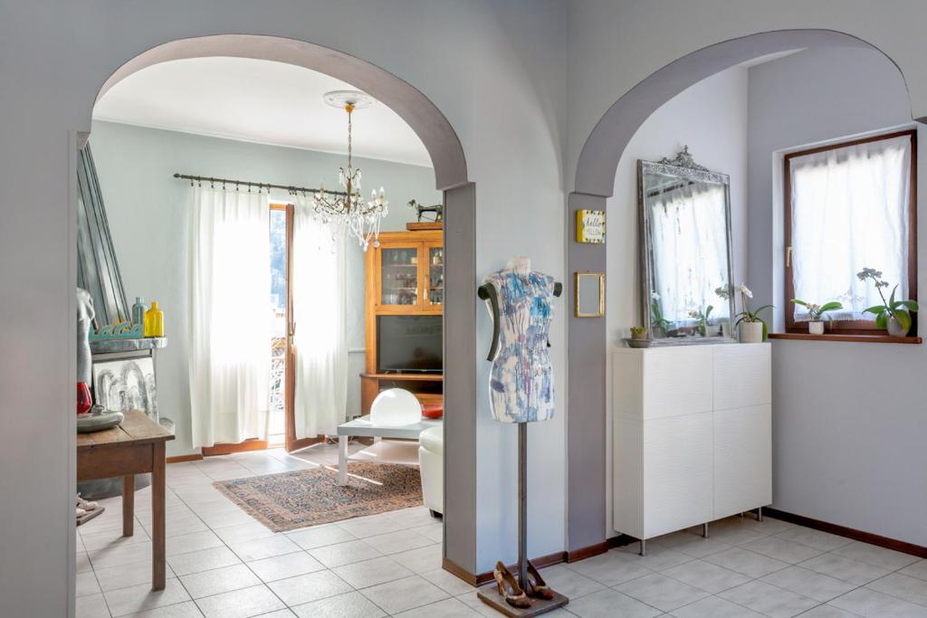 an archway in a living room with a table and a mirror at Casa Barbera in Cannobio