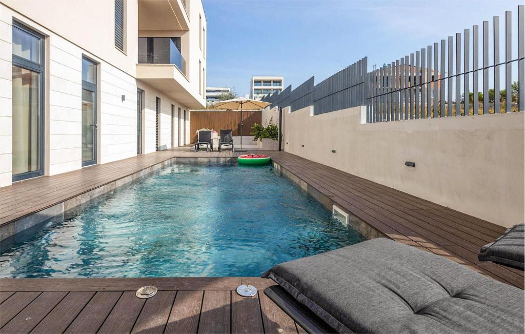 a swimming pool in the middle of a building at Nice Apartment In Sveti Filip I Jakov in Sveti Filip i Jakov