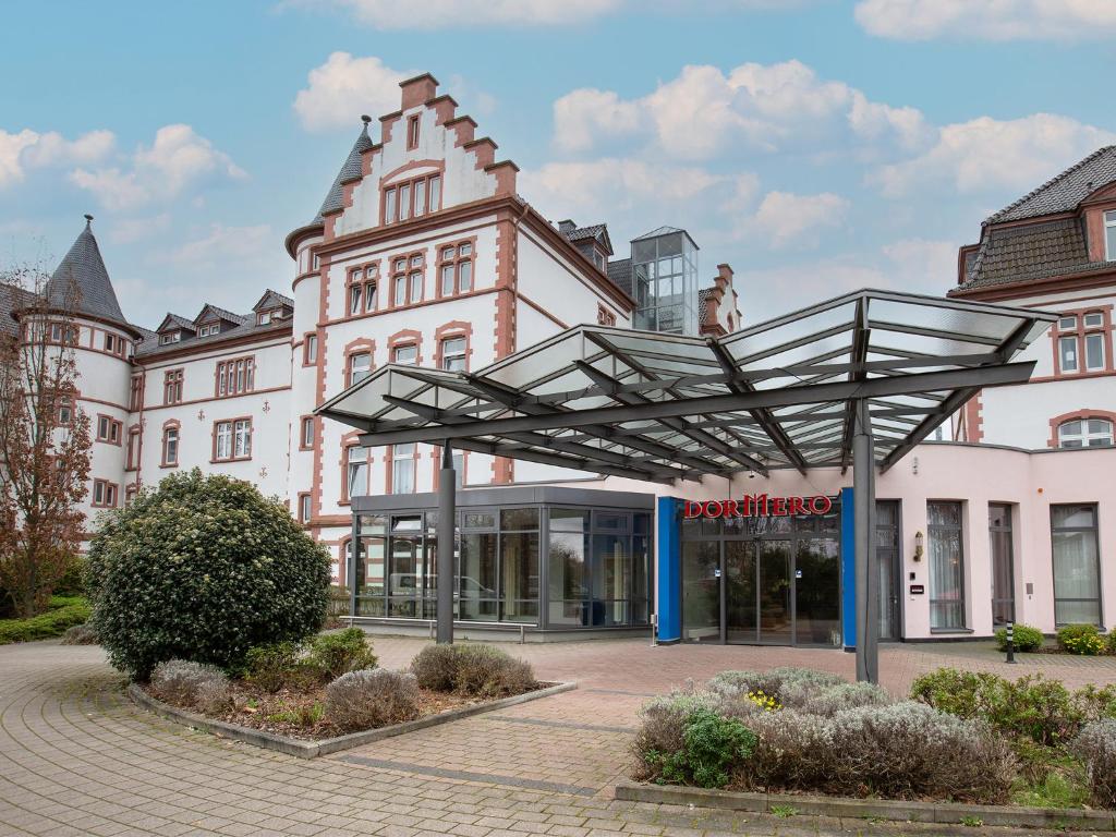 un bâtiment avec un toit en verre devant lui dans l'établissement DORMERO Hotel Worms, à Worms