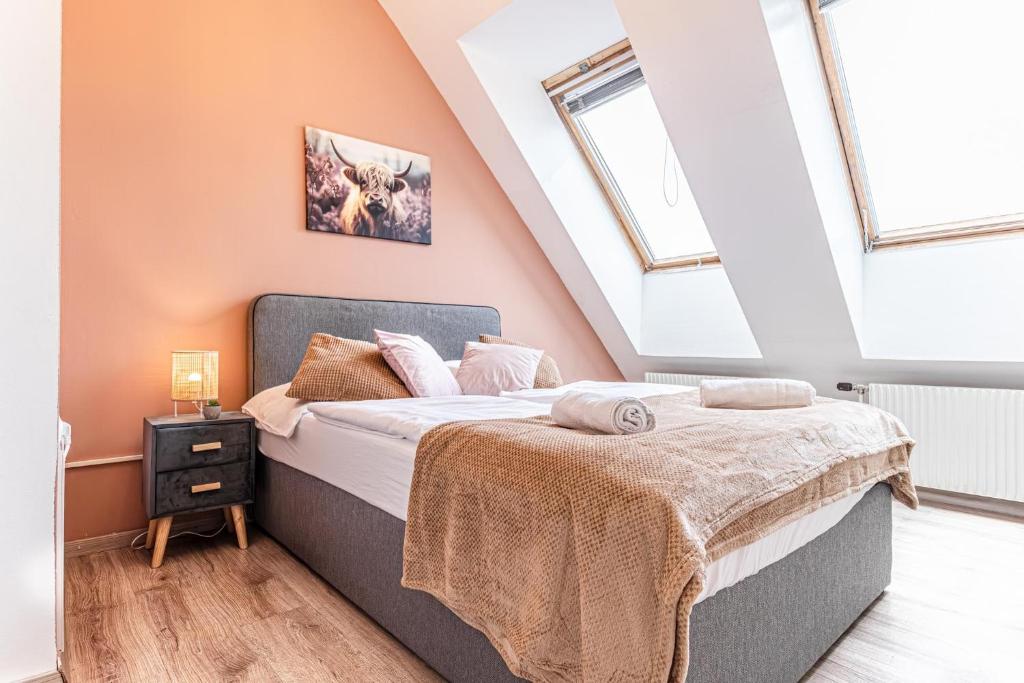 a bedroom with a bed and two windows at Hauptbahnhof Boutique Rooms - Virtual Reception & Self-Checkin in Vienna