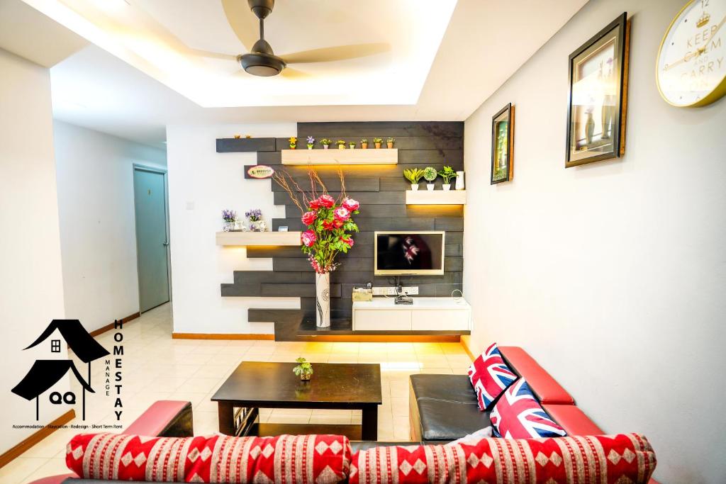 a living room with a couch and a table at QQSweetHomeLovelyBktChedang10bedroom Homestay (15-17pax) in Seremban