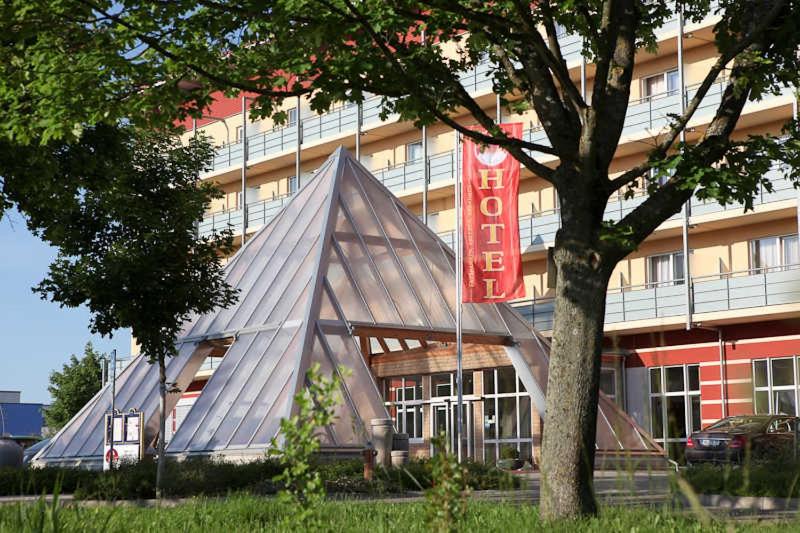 a large building with a sign in front of it at Kurhotel Pyramide AG in Bad Windsheim