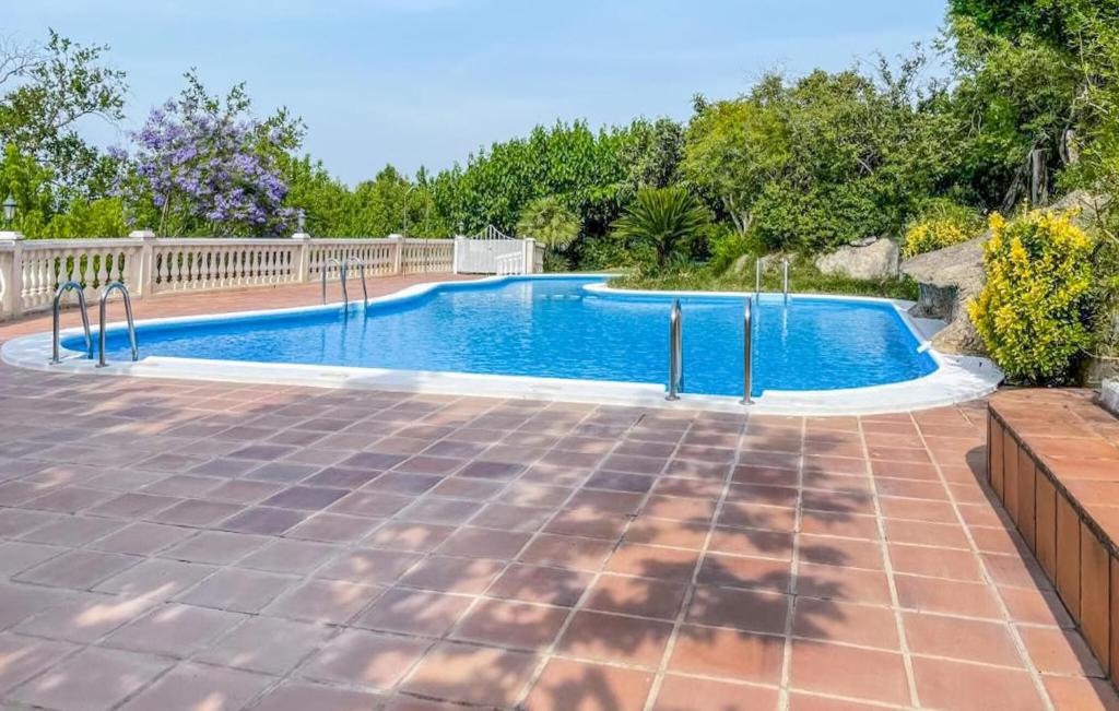 a swimming pool in a backyard with a fence at Beautiful stacaravan In Xtiva With Kitchenette in Xàtiva