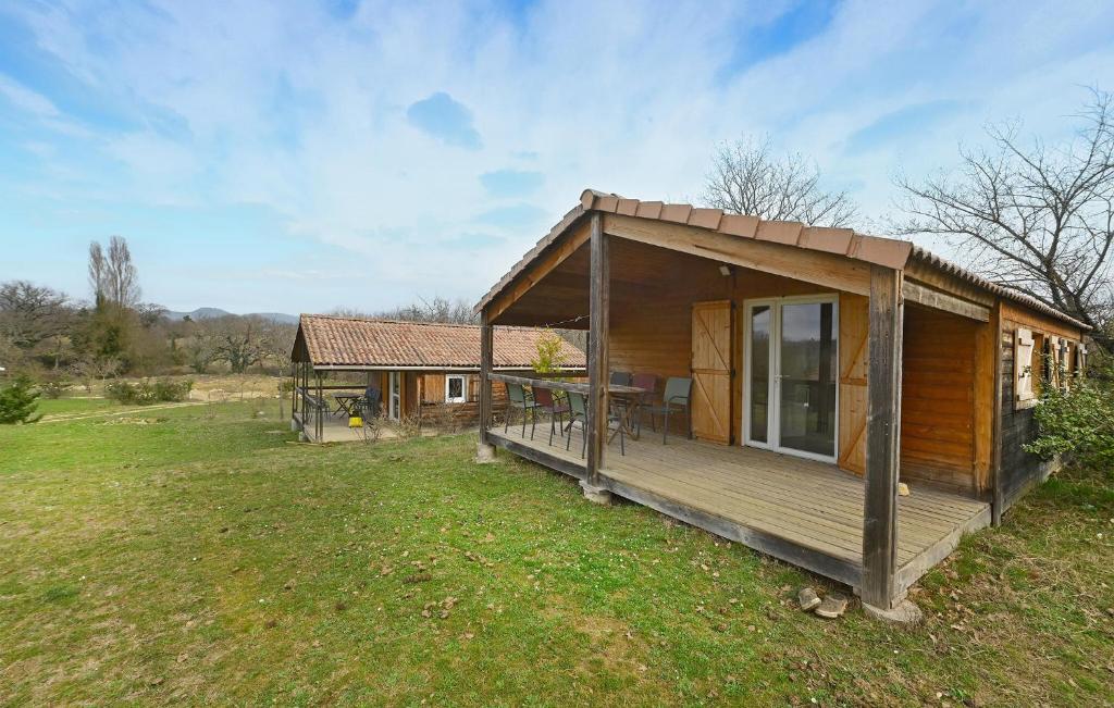 a wooden cabin with a large deck in a field at 2 Bedroom Stunning Home In Barjac in Barjac