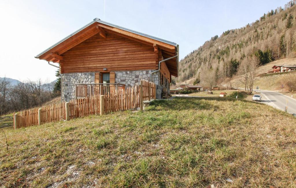 a small house on a hill with a fence at Beautiful Home In Castello Tesino With Kitchen in Castello Tesino