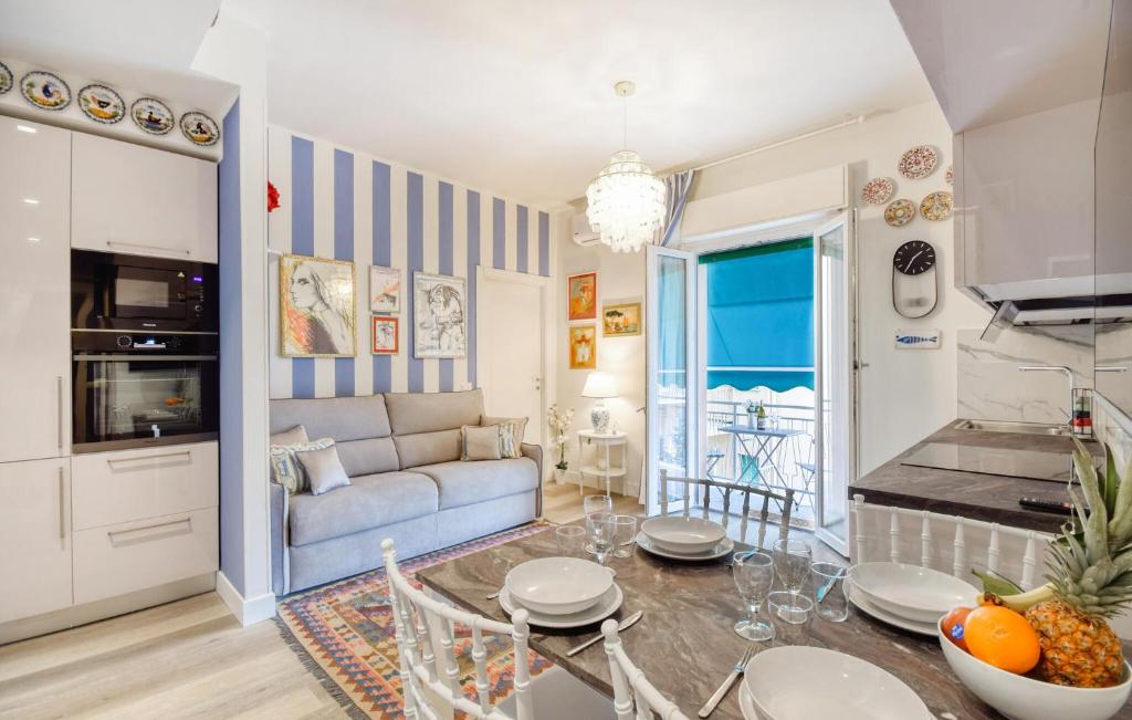 a kitchen and living room with a table and a couch at Cozy Apartment In Chiavari With Wifi in Chiavari