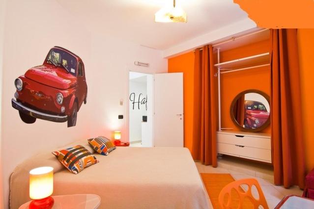a bedroom with a bed with a car on the wall at Tra Gianicolo e Trastevere in Rome